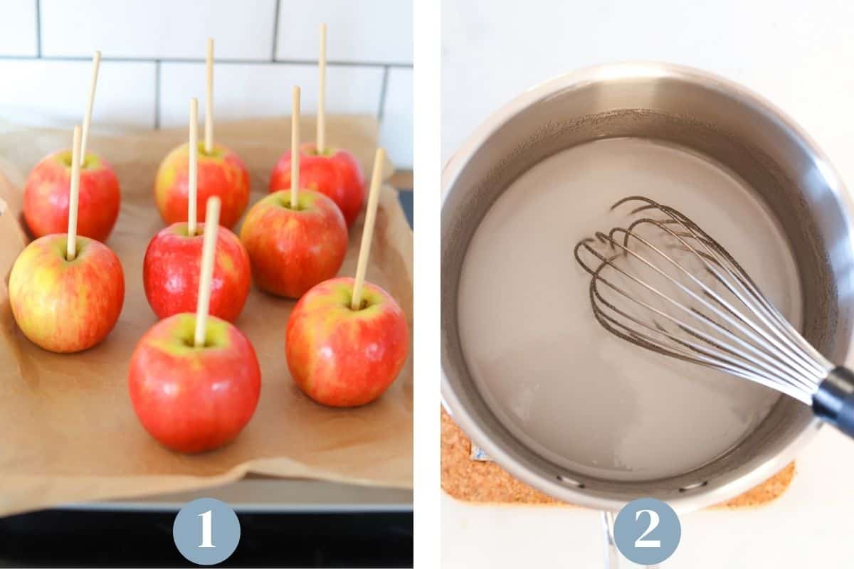 Apples on a baking sheet with wooden sticks.